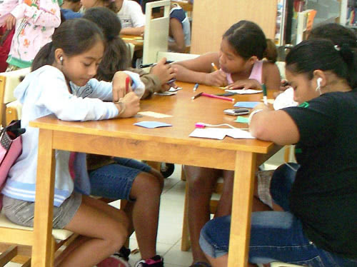 Children practice before writing postcards
